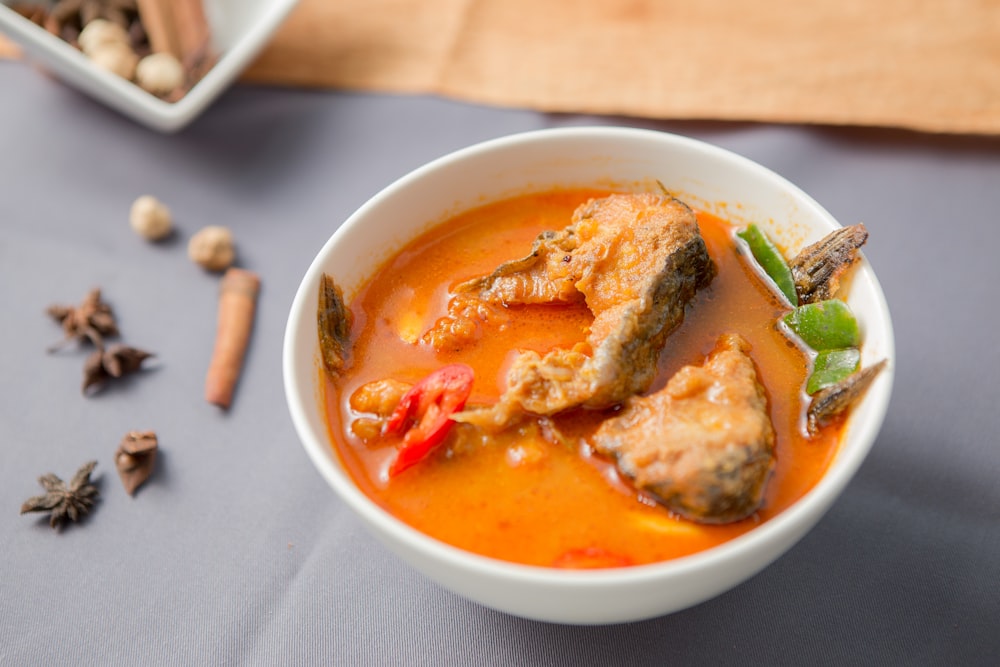 a bowl of soup with meat and vegetables