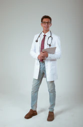 a male doctor in a white coat and tie