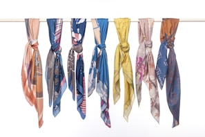 A collection of colorful scarves neatly arranged in a flat lay.