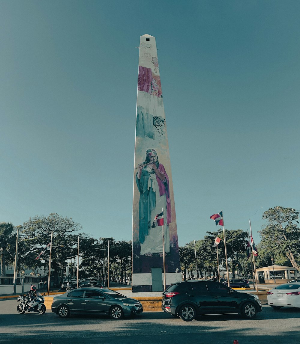 a tall monument with a painting on it