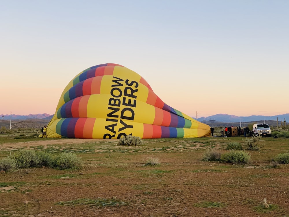 a large hot air balloon sitting in the middle of a field