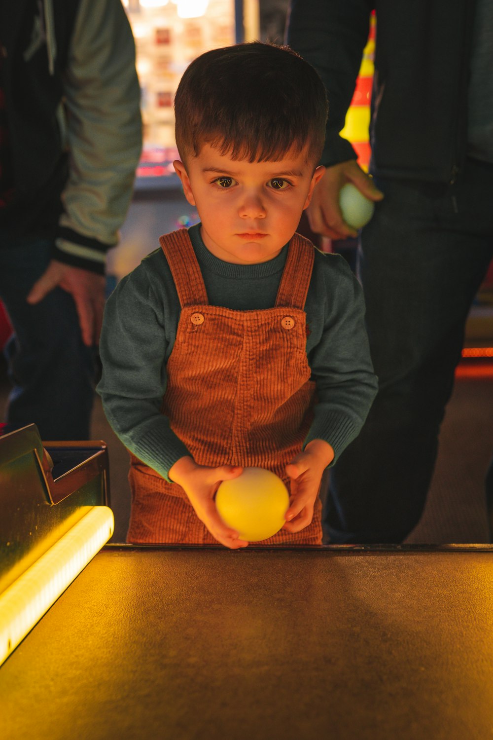 a young boy holding an egg in his hands