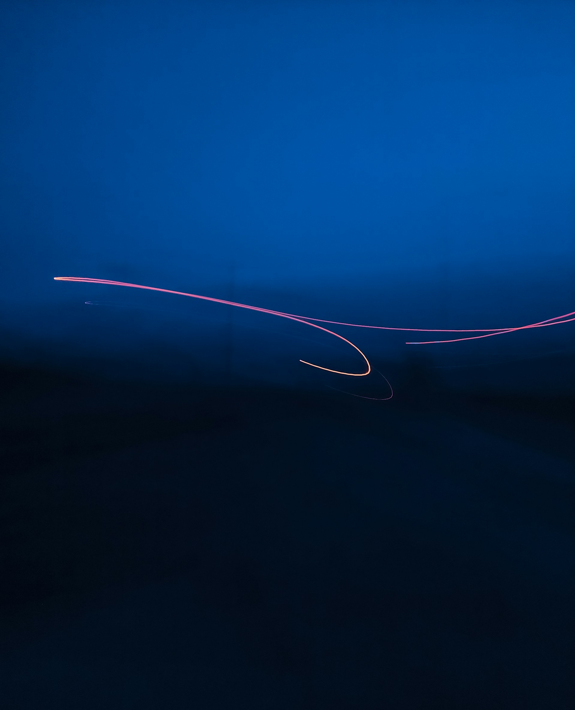 a long exposure photo of a plane in the sky