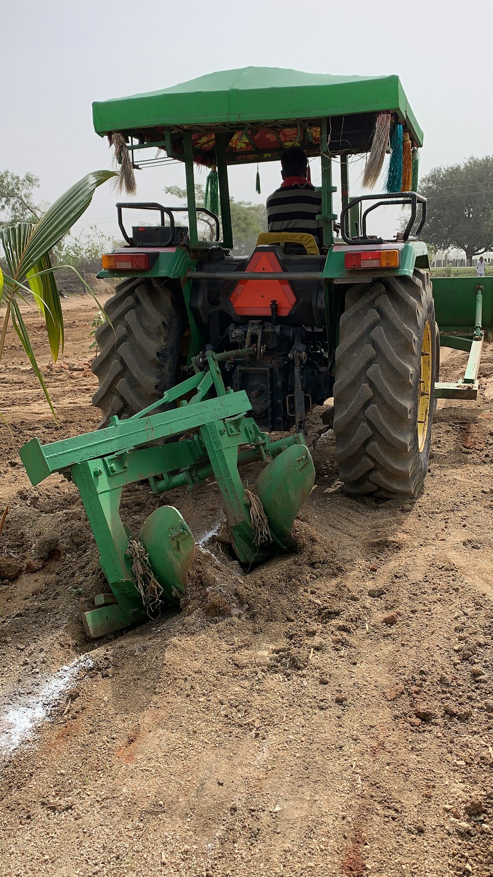 a tractor is parked on a dirt field