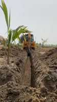 Mechanical excavator digging trenches for cable routing at a solar farm.