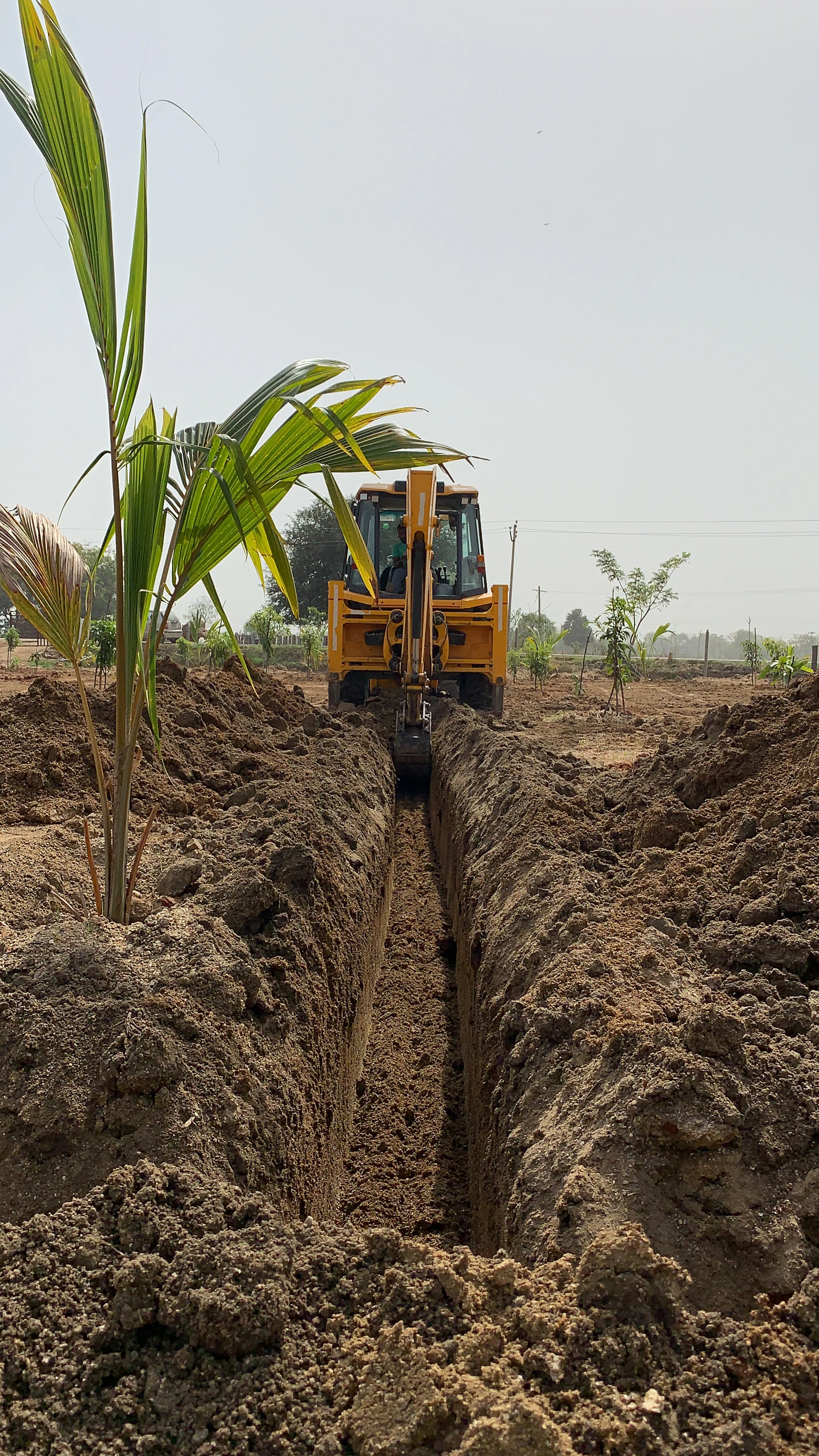 Heavy machinery working a trench near a pipeline installation