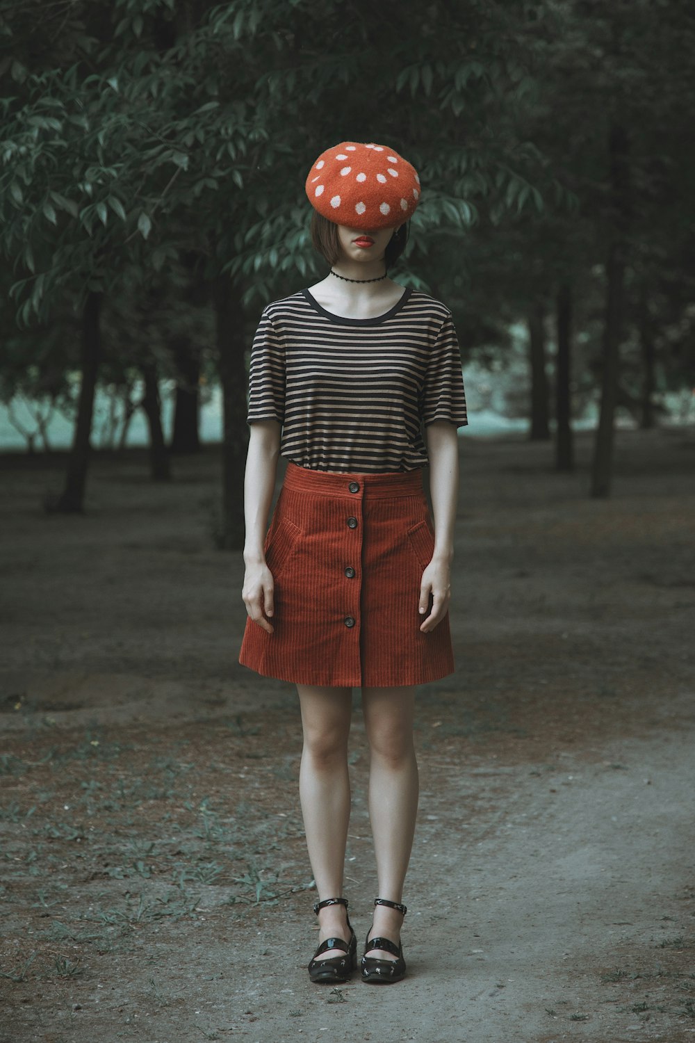 a woman wearing a red polka dot hat
