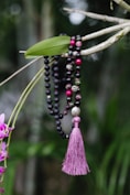 a bunch of beads hanging from a tree
