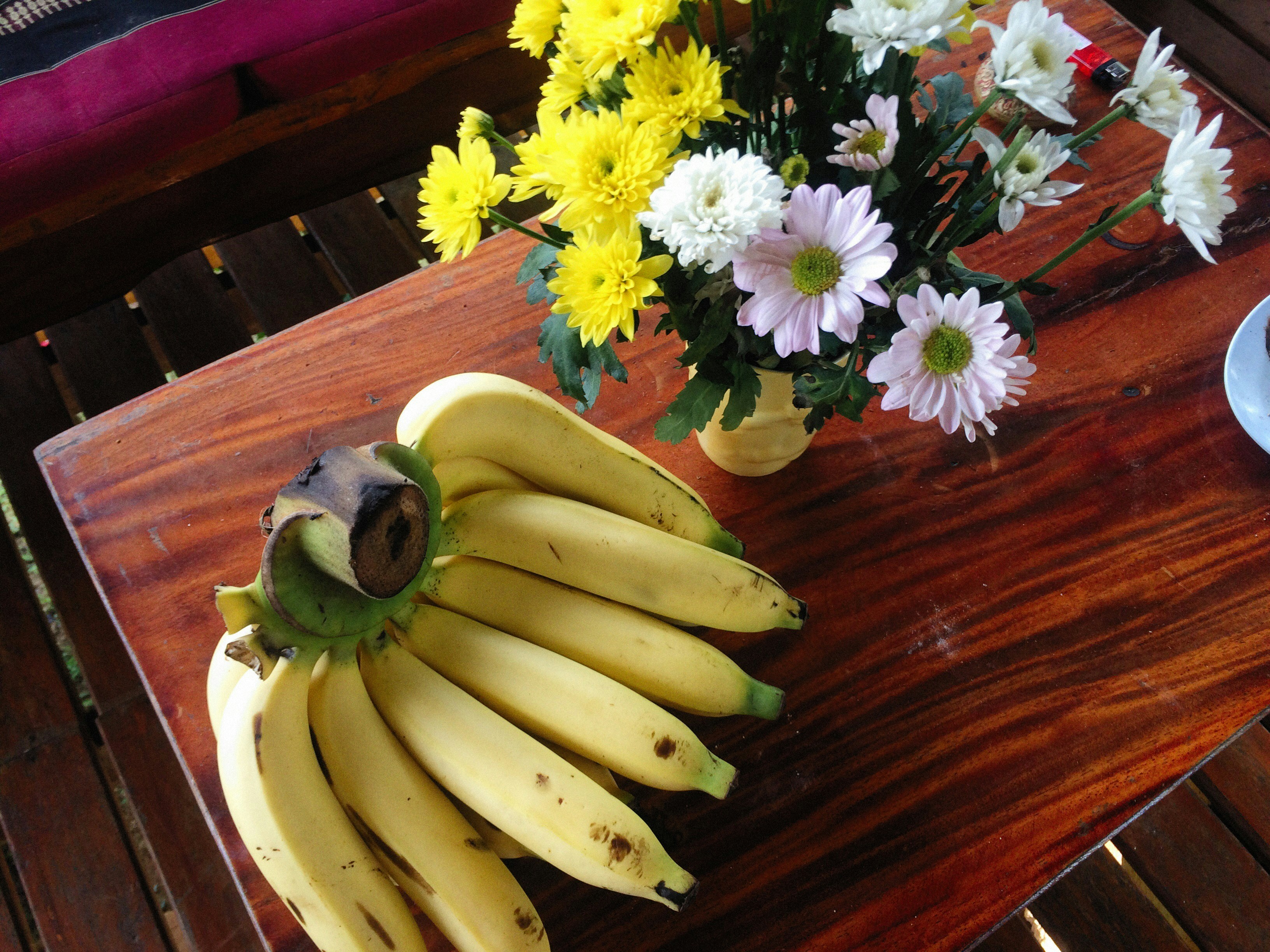 a bunch of bananas sitting on top of a wooden table