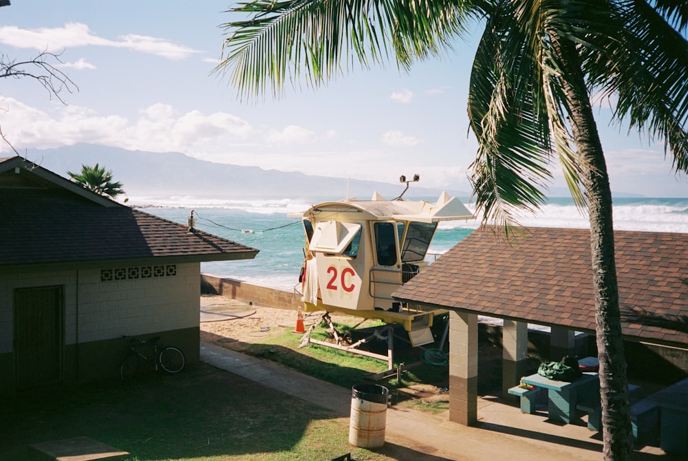 a boat sitting on top of a beach next to the ocean