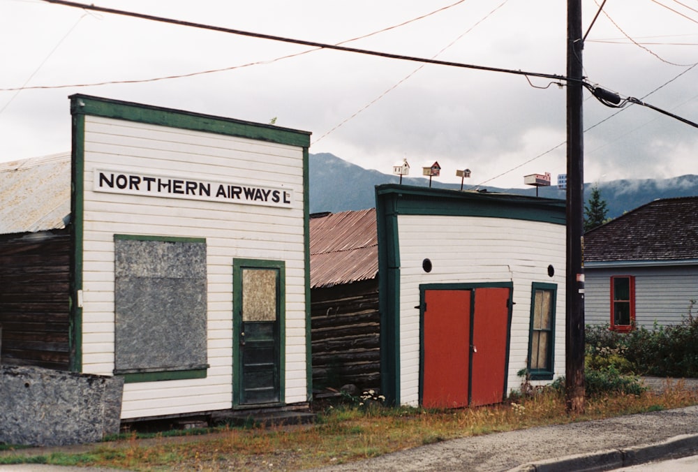 a building with a red door on the side of a road