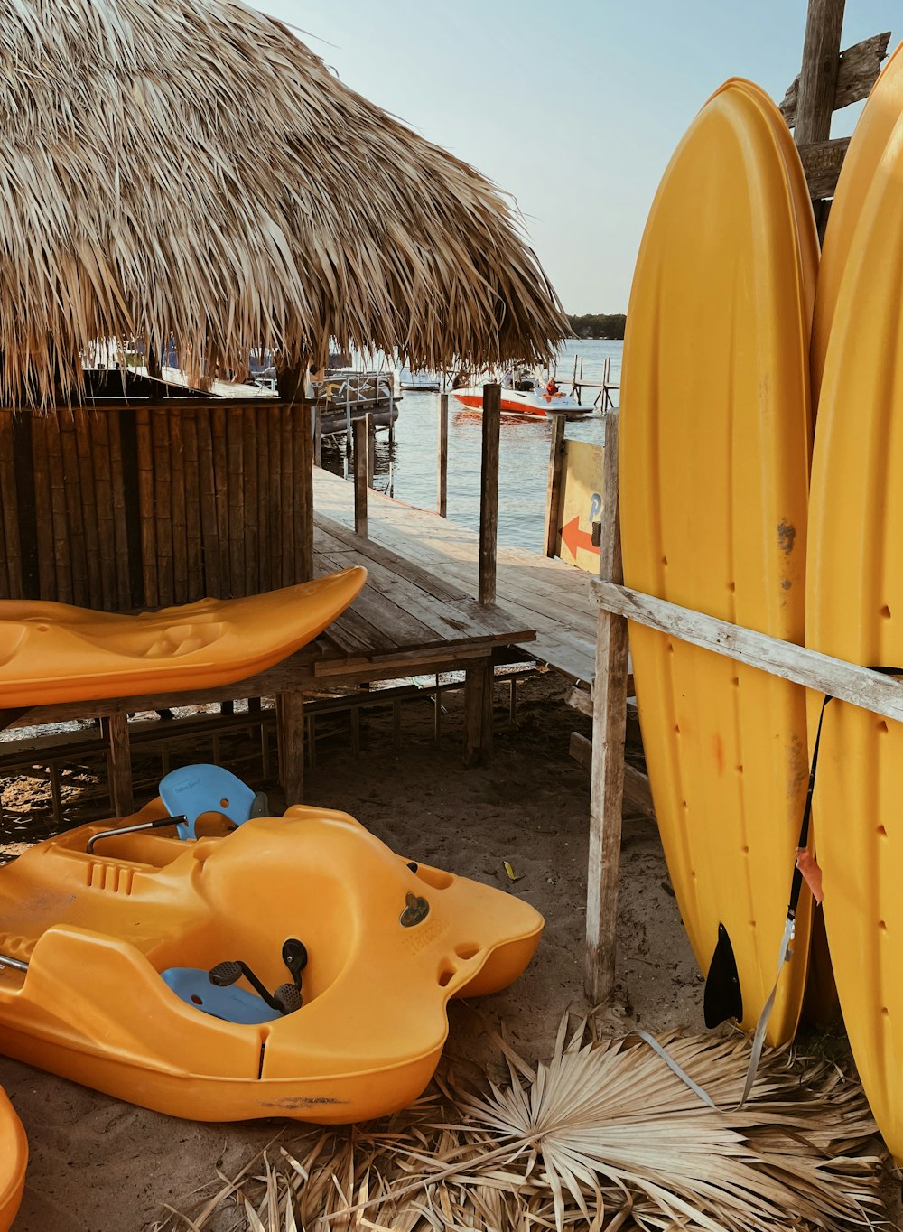 a group of yellow kayaks sitting on top of a sandy beach