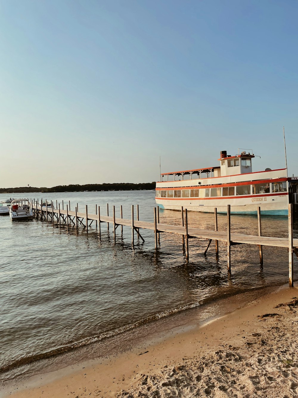 a boat is docked at a pier on the water