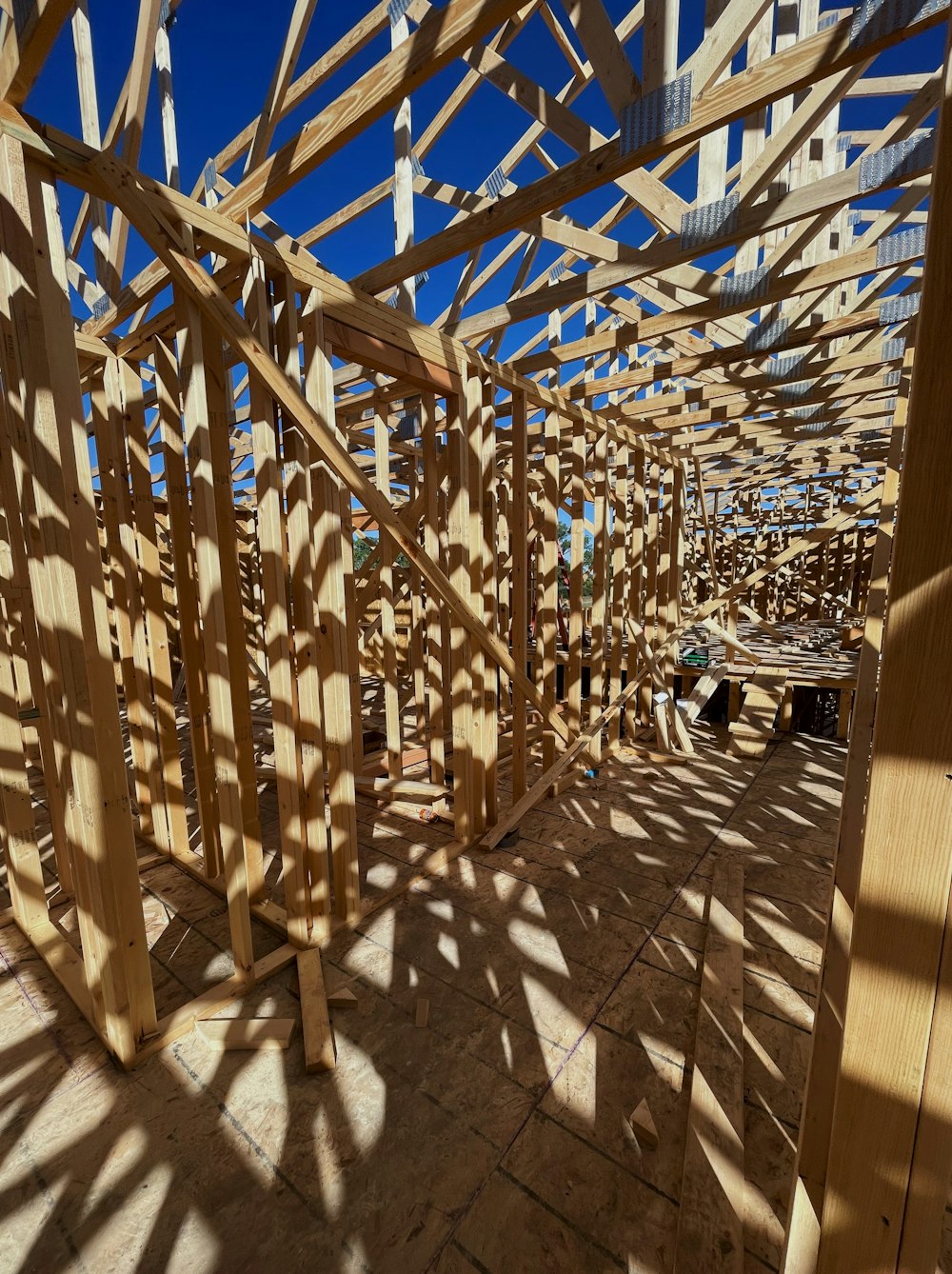 a building under construction with lots of wooden beams
