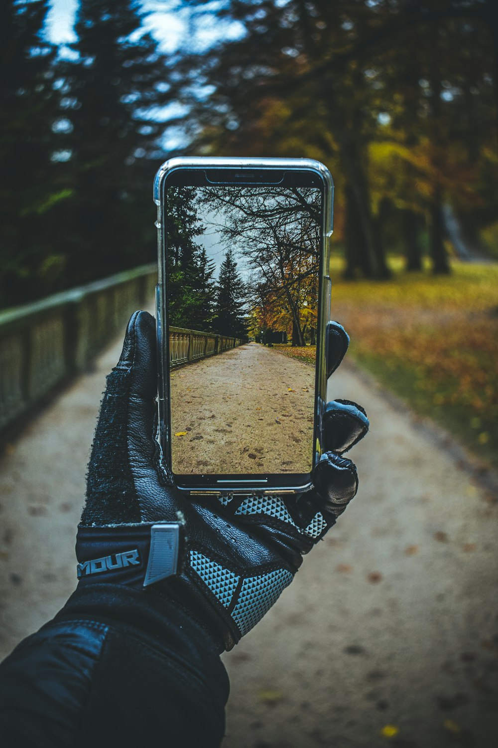 a person taking a picture of a road with a cell phone