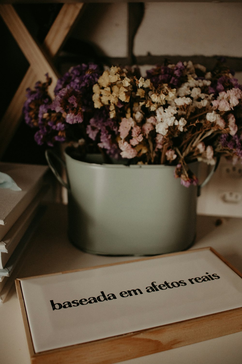 a bunch of flowers sitting in a bucket on a table