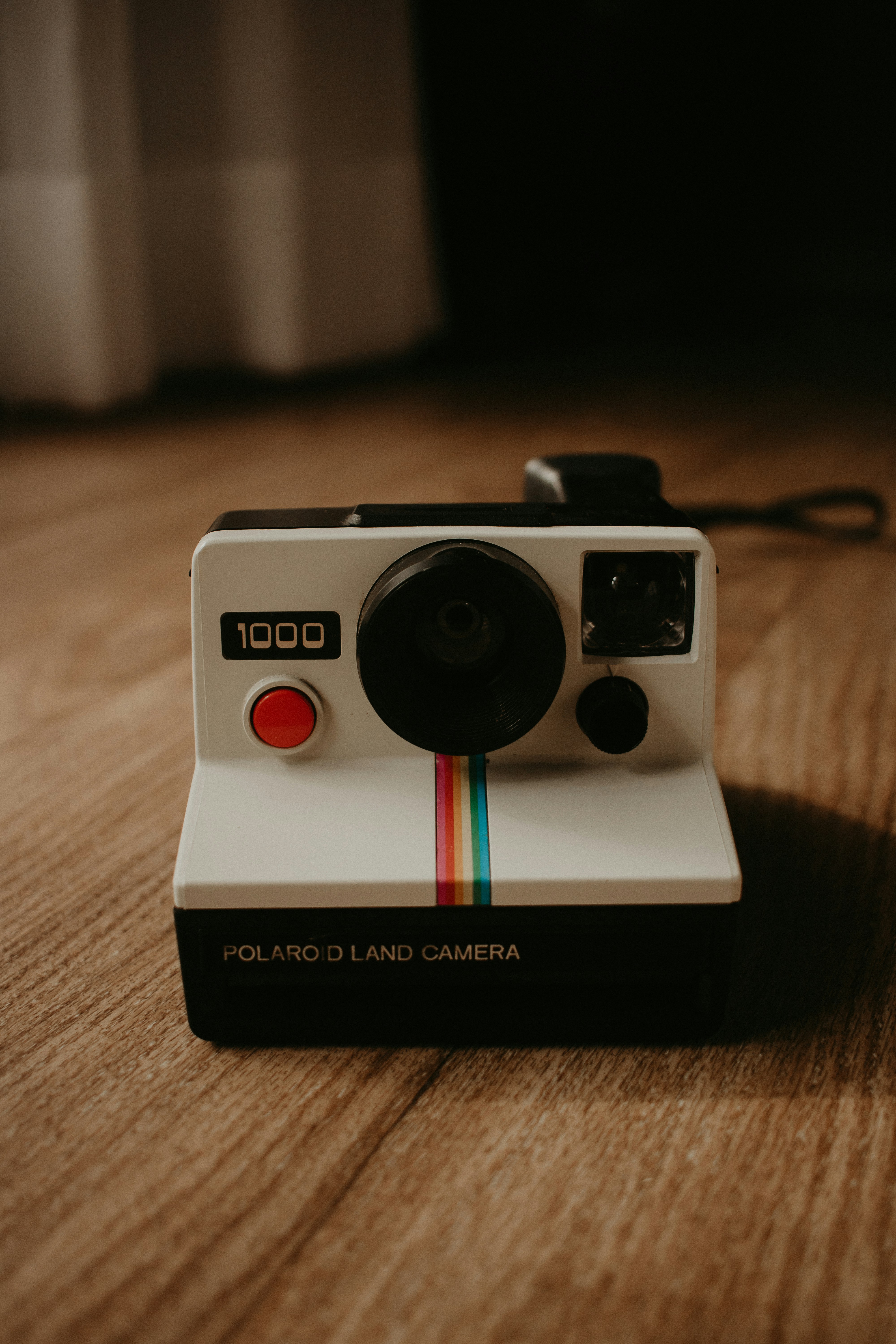 a polaroid camera sitting on top of a wooden table