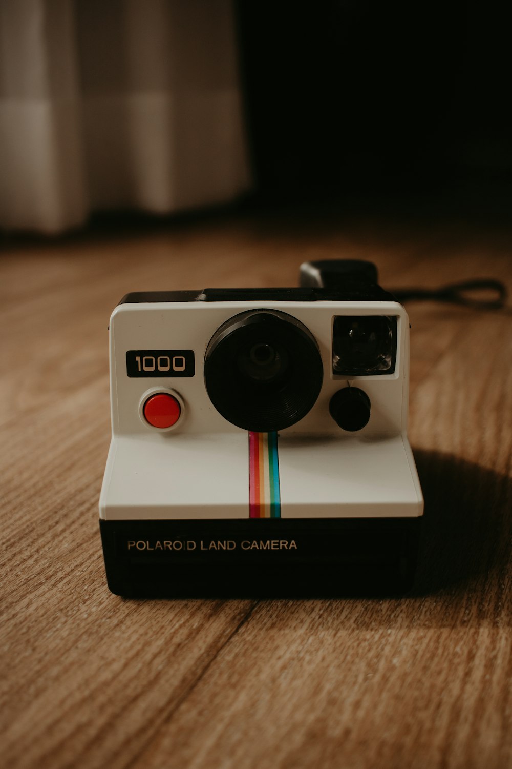a polaroid camera sitting on top of a wooden table