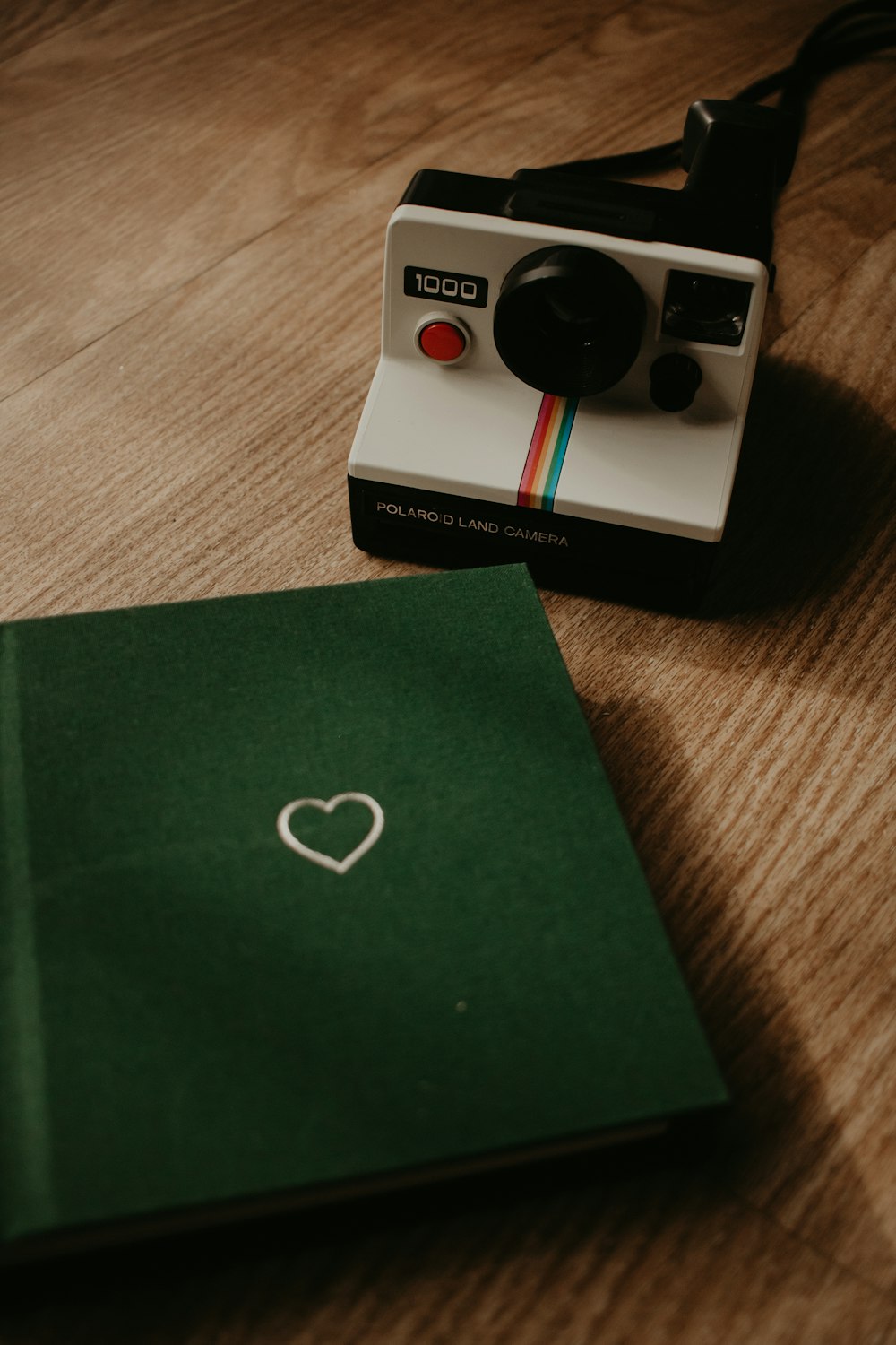 a polaroid camera sitting on top of a wooden table