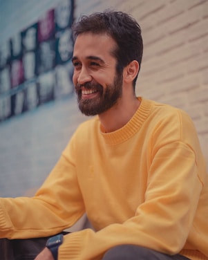 a man with a beard sitting on the ground