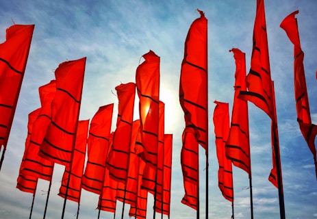 a bunch of red flags flying in the air