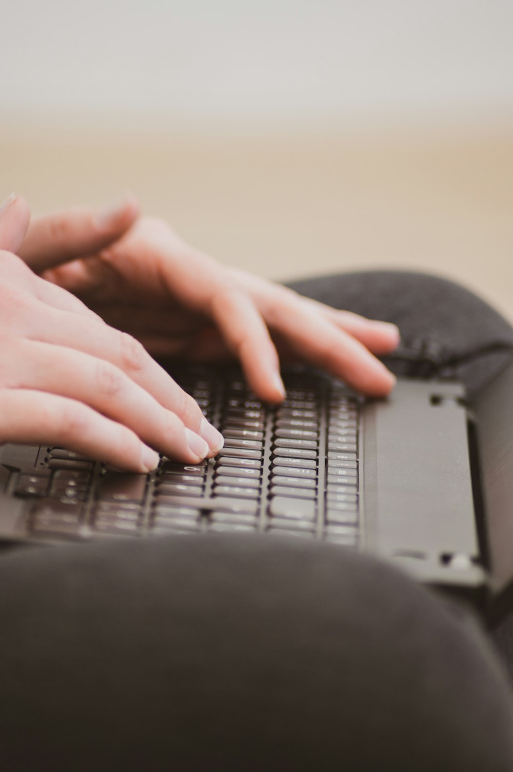 a woman's hands on a laptop keyboard