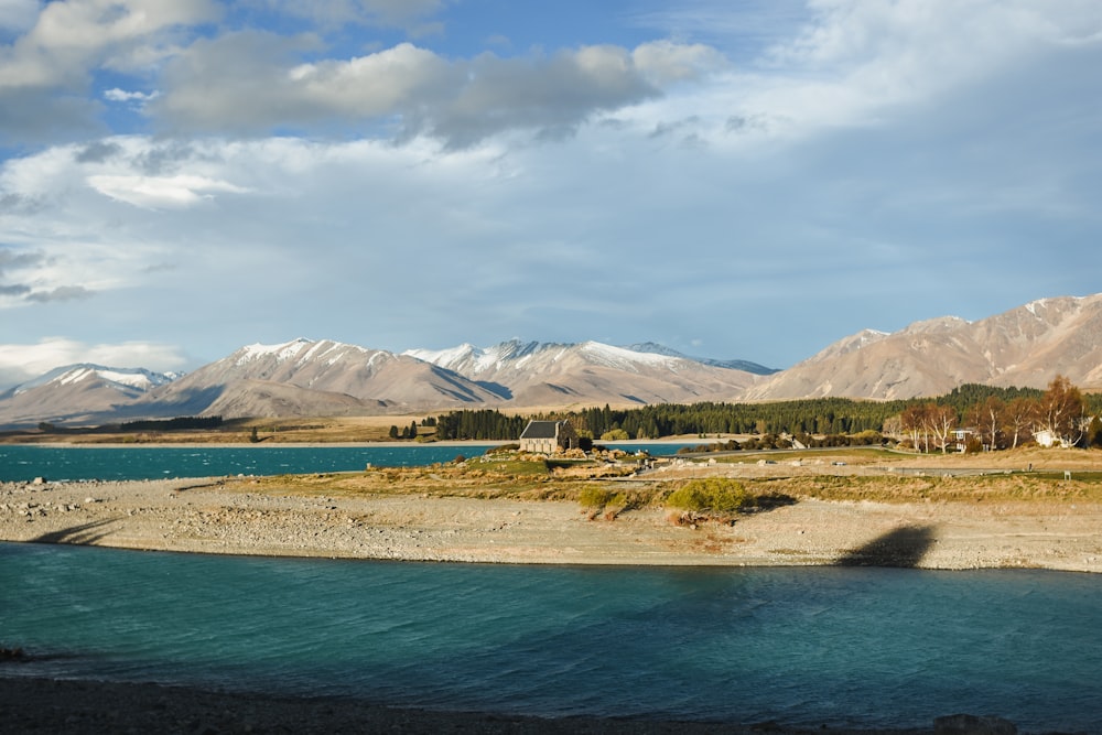 a body of water with mountains in the background