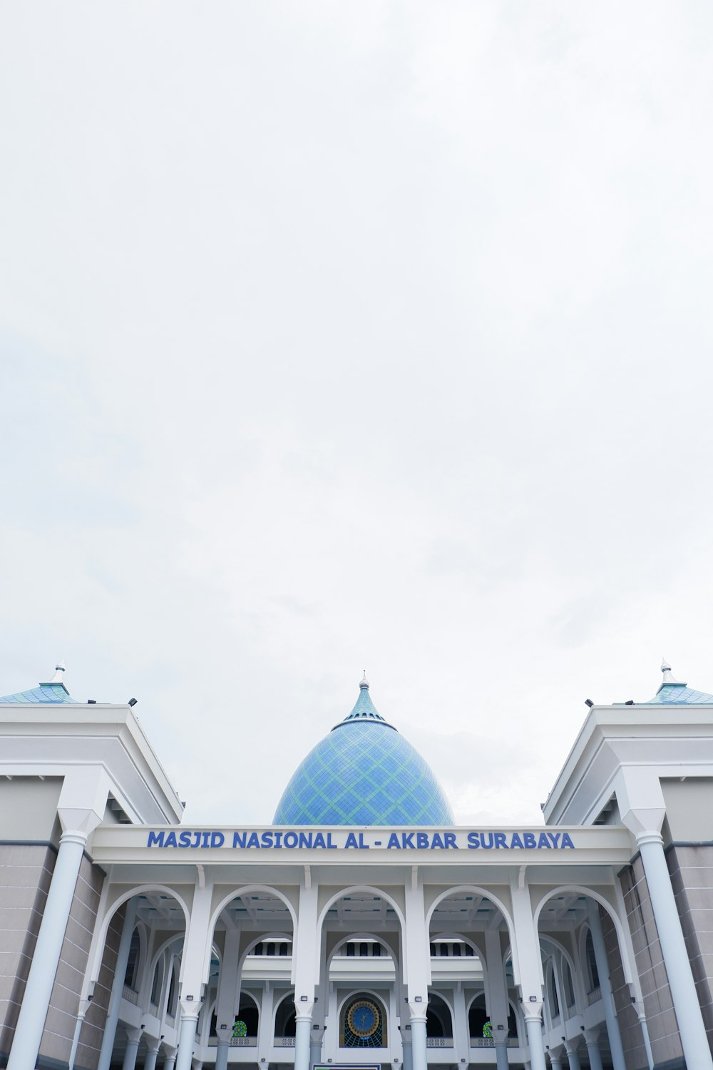 a large white building with a blue dome on top