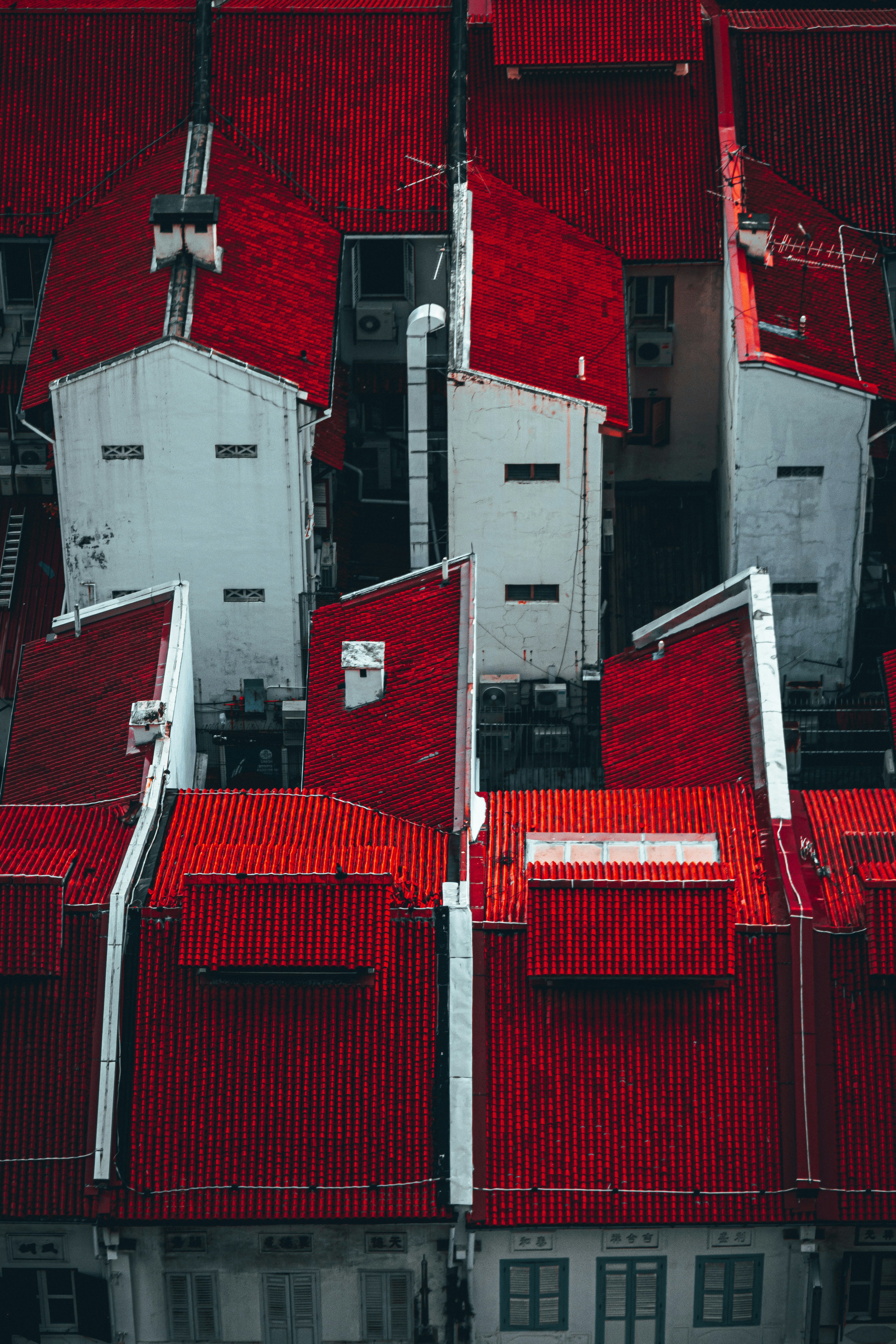 an aerial view of a building with red roof tiles