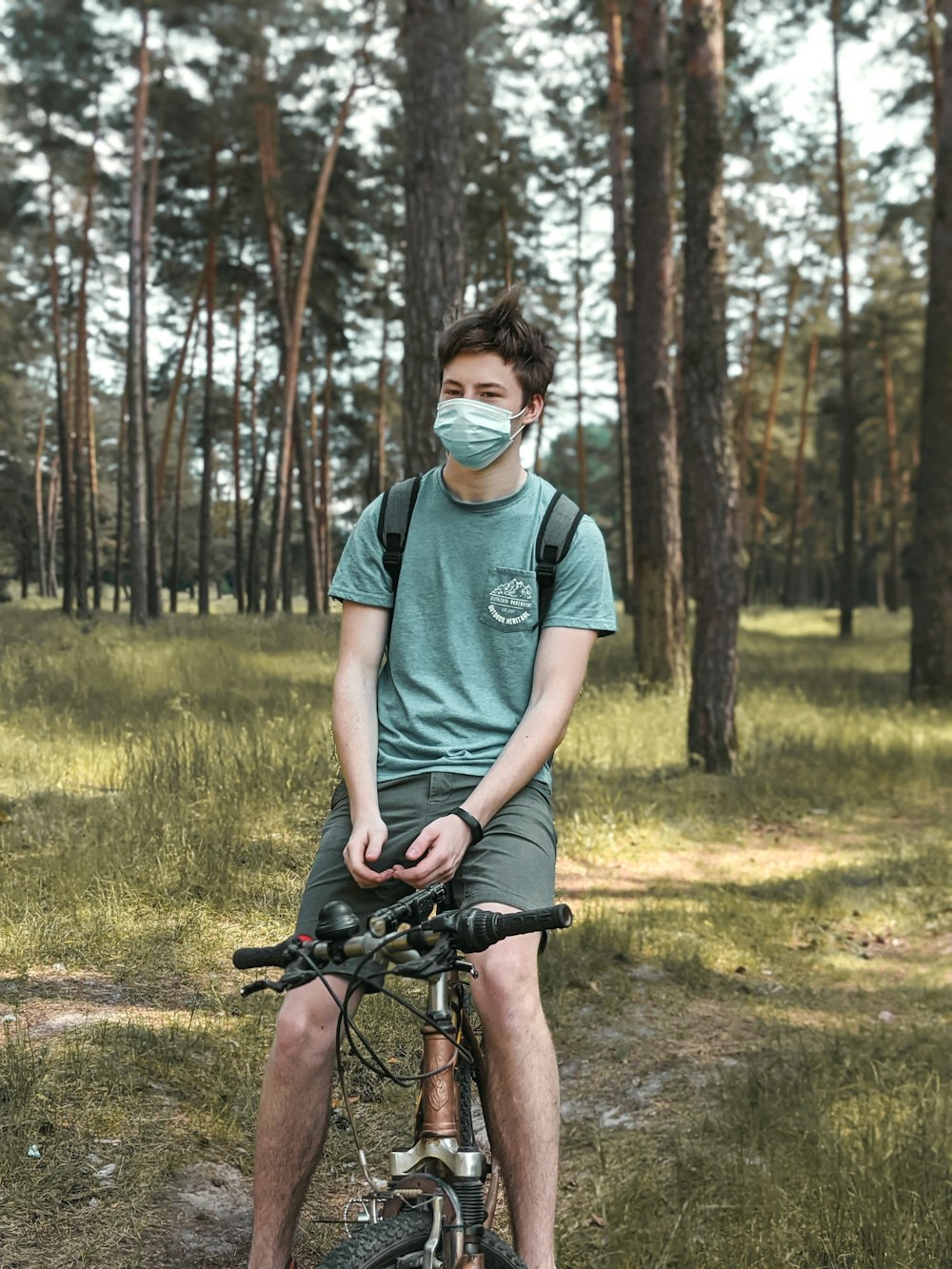 a man riding a bike down a dirt road