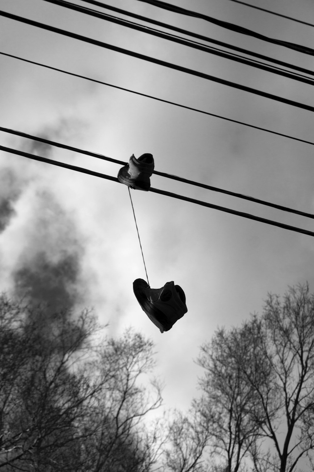 a pair of shoes hanging from a power line