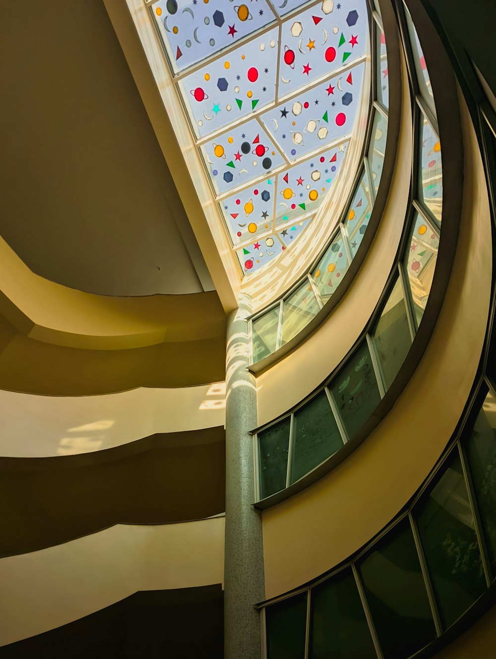 a spiral staircase with a skylight in the center