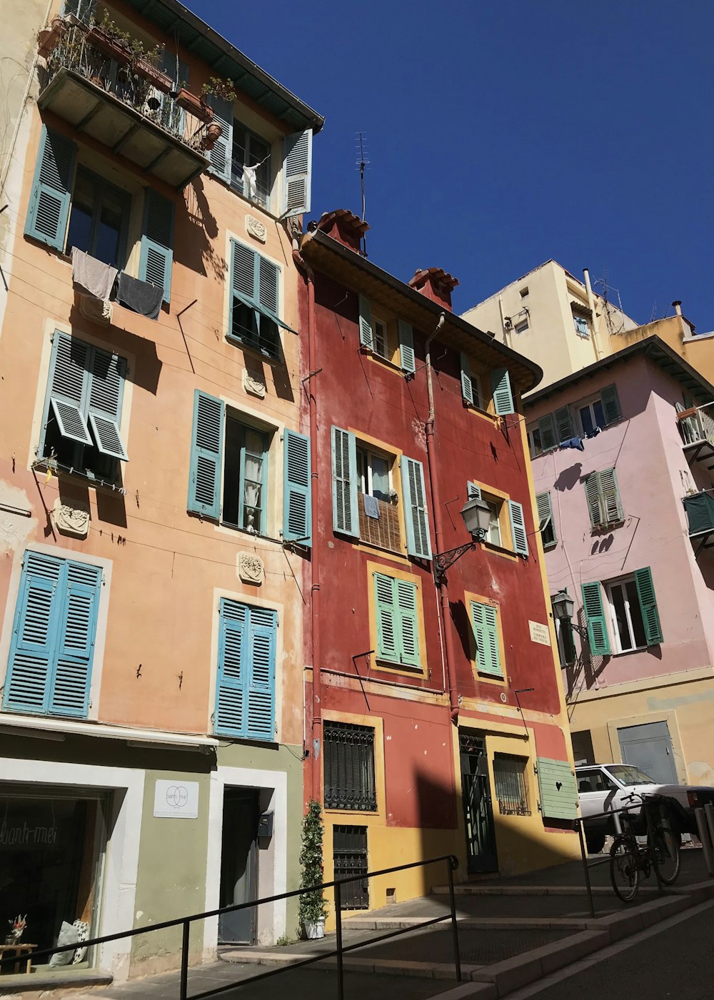 a row of buildings with blue shutters on the windows