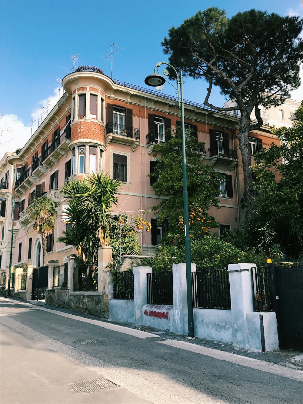 a tall building with lots of windows next to a street