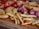Close-up of a variety of colorful fast food snacks on a wooden table.