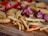 A close-up of a delicious assortment of frozen savory snacks on a wooden table.