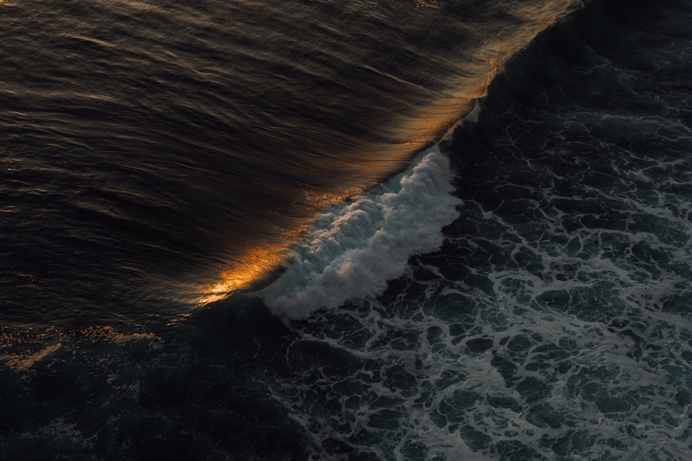 an aerial view of a body of water with waves