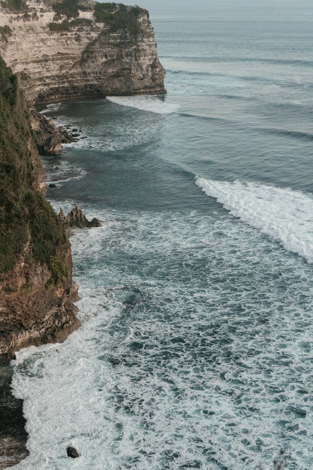 a view of a body of water with a cliff in the background