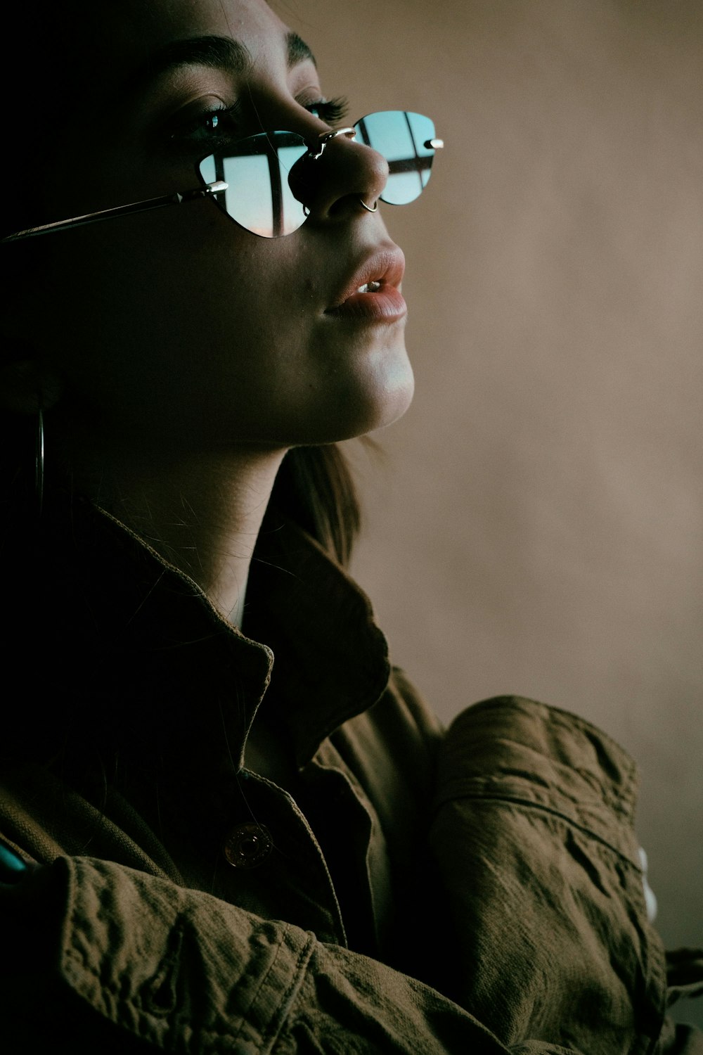 a woman wearing glasses looking off into the distance