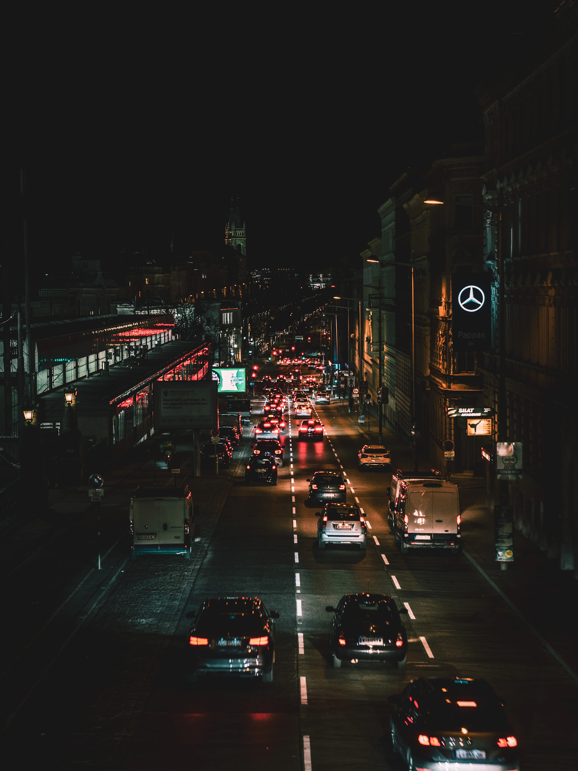 a city street filled with lots of traffic at night