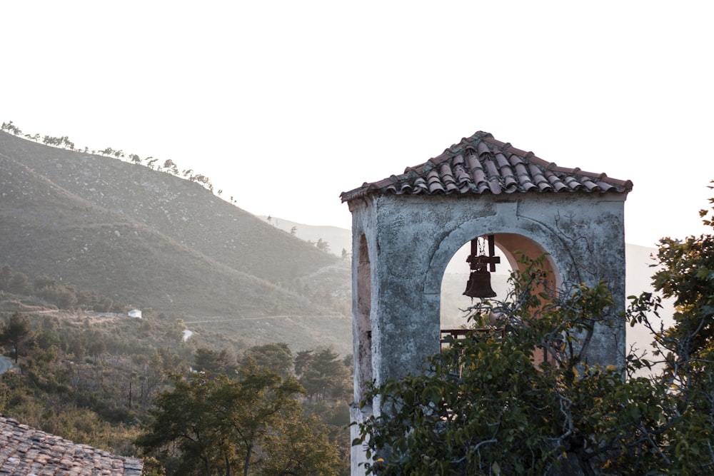 a bell tower with a bell on top of it