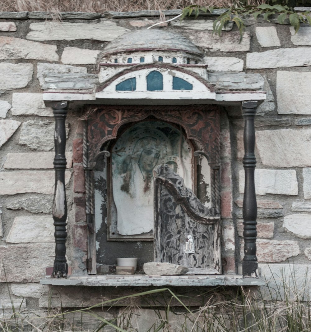 a stone wall with a window and a door