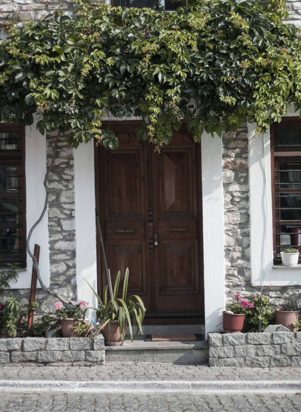 a stone house with a wooden door and window