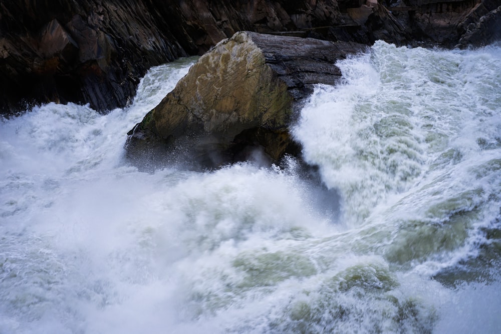 a large rock sticking out of the middle of a river