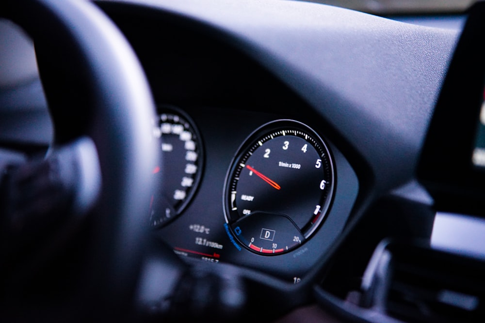 a close up of a car dashboard with a speedometer