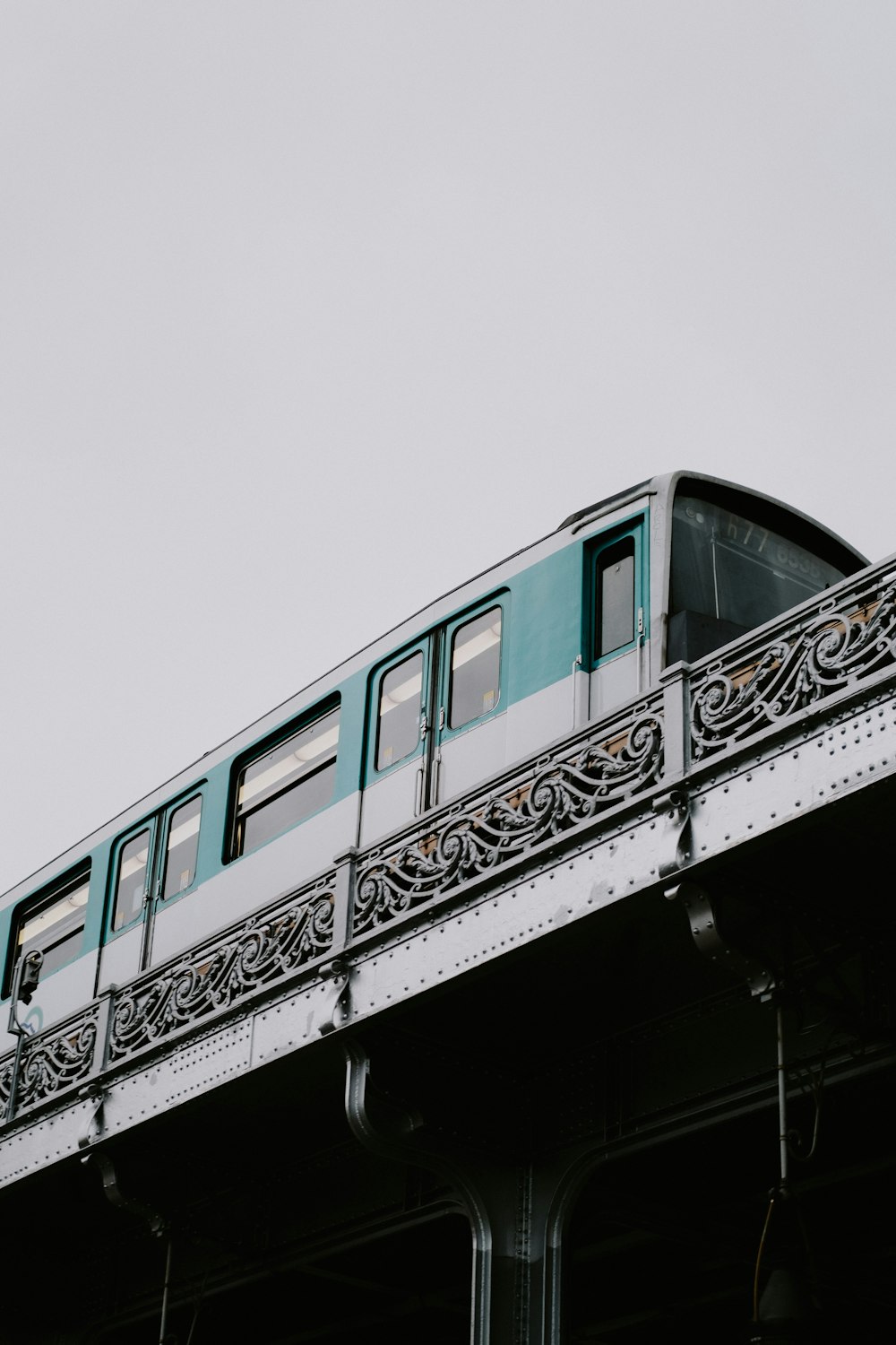 a train traveling over a bridge on a cloudy day