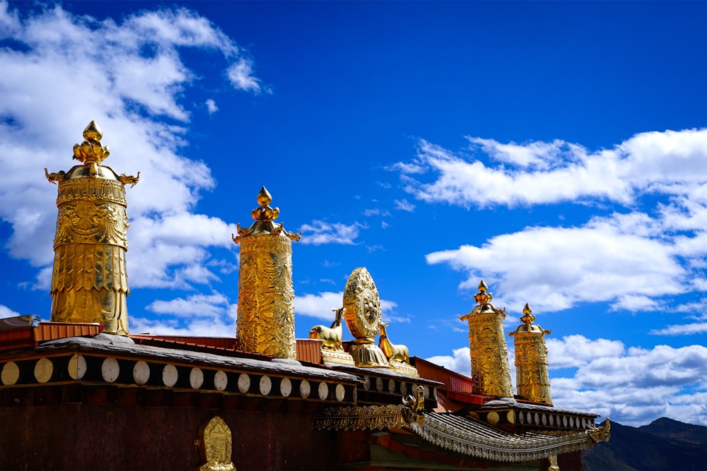 a group of golden statues on top of a building