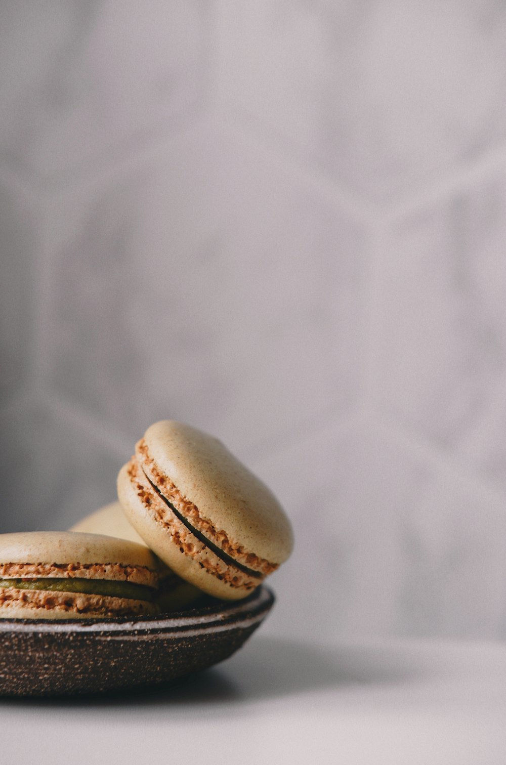 a couple of macaroons sitting on top of a plate