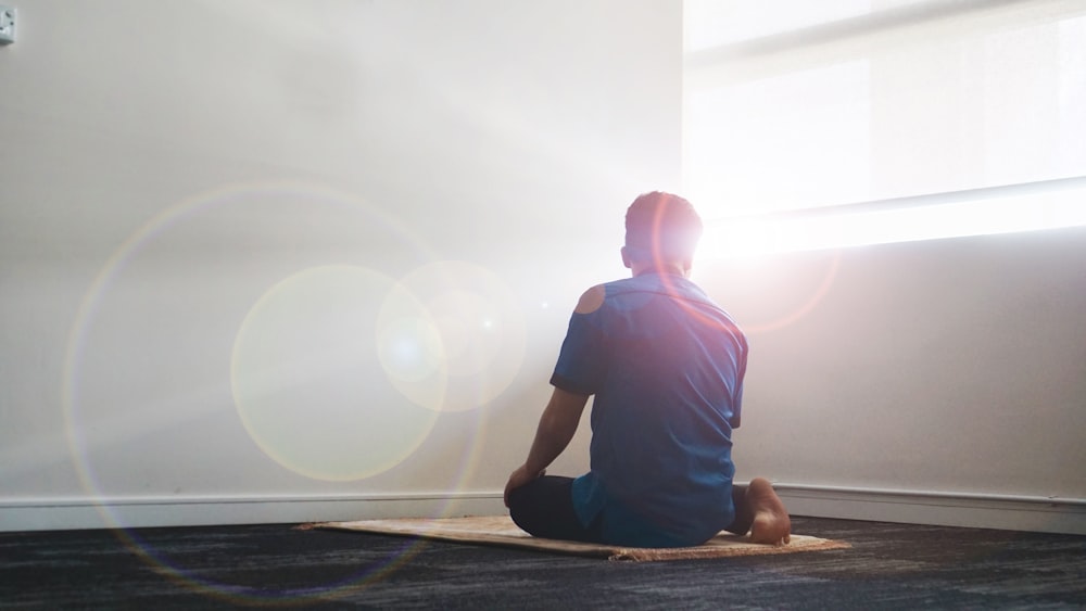 a person sitting on a rug in a room