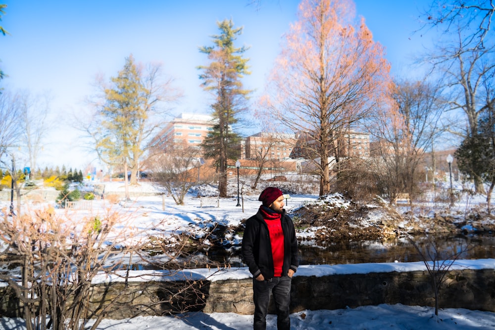 a woman standing in the snow in a park